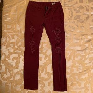 Maroon “ripped” skinny pants.